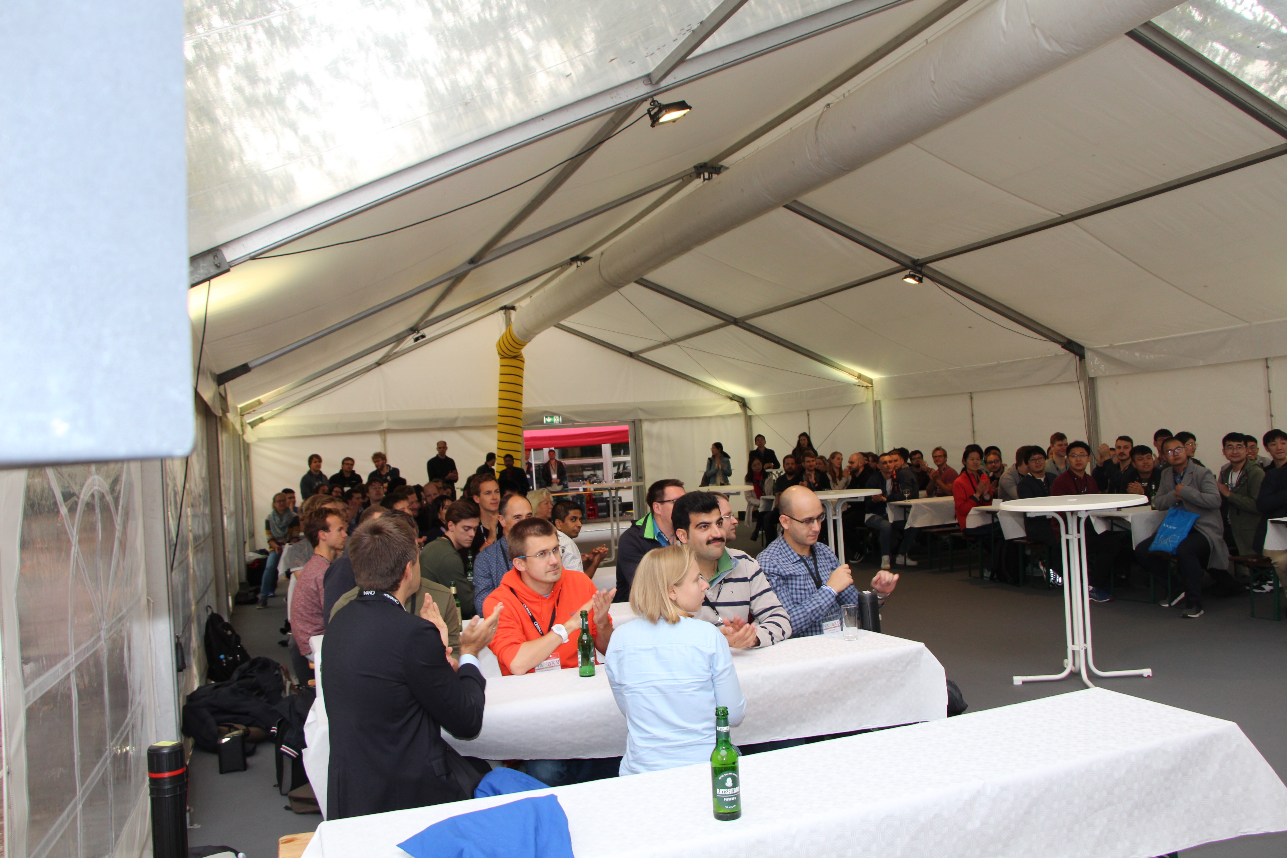 Picture from the workshop with people gathering in a big tent and sitting at tables Picture from the workshop with people gathering in a big tent and sitting at tables